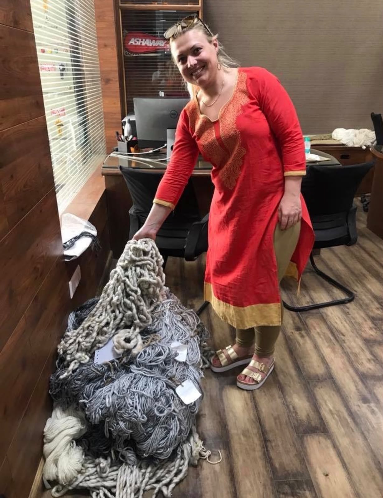 Leah inspecting yarn during a Zoya sourcing trip