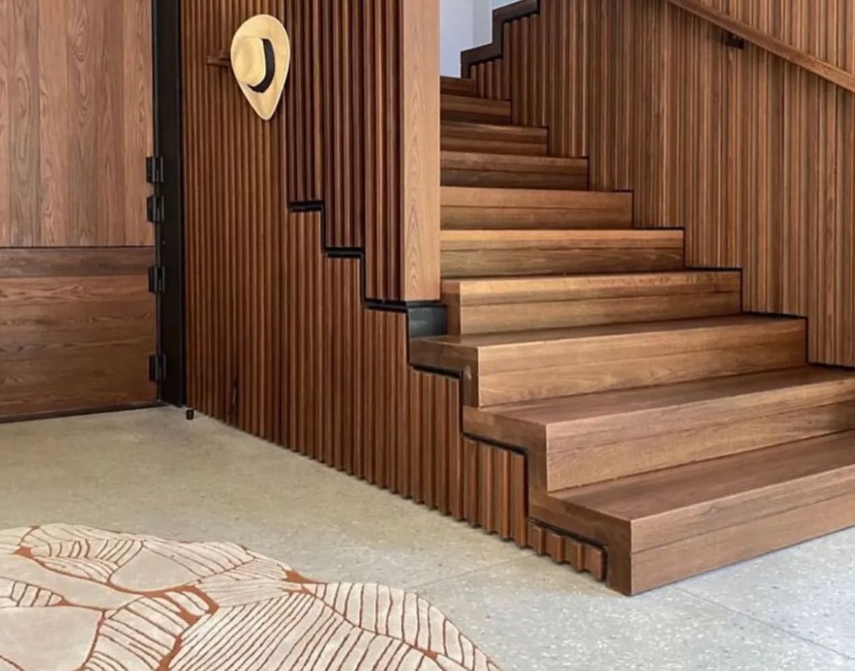 Finished Zoya rug installed in a timber clad entrance interior