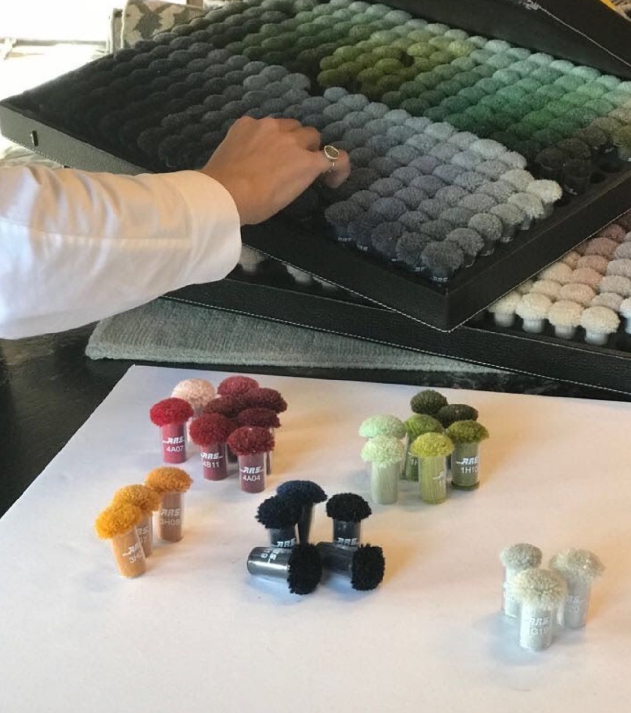 Selecting colours from Zoya pom pom trays during the sampling stage